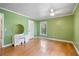 Bright bedroom featuring wood floors, a ceiling fan, and natural light at 400 Simpson Ne Rd, White, GA 30184