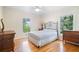 Well-lit bedroom featuring wood floors, updated windows, and a ceiling fan at 400 Simpson Ne Rd, White, GA 30184