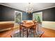 Charming dining room featuring a vintage chandelier and dark accent walls with a glimpse into the living room at 400 Simpson Ne Rd, White, GA 30184