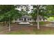Charming brick home featuring a welcoming front porch and beautiful landscaping at 400 Simpson Ne Rd, White, GA 30184
