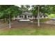 Well-maintained front yard with mature trees, a circular driveway, and an inviting facade at 400 Simpson Ne Rd, White, GA 30184