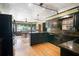 Elegant kitchen with dark cabinetry, granite countertops, and stainless steel appliances at 400 Simpson Ne Rd, White, GA 30184