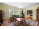 Inviting living room with large windows, cozy seating, a classic rug, and a festive Christmas tree at 400 Simpson Ne Rd, White, GA 30184