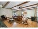 Bright living room featuring hardwood floors, exposed beams, and comfortable seating with easy access to the outdoors at 400 Simpson Ne Rd, White, GA 30184