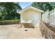 Exterior view of a quaint pool house with a utility sink, nestled beside the pool and white picket fence at 400 Simpson Ne Rd, White, GA 30184