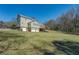 Spacious backyard featuring a two-car garage, and an oversized deck overlooking the lawn at 1103 Wallington Nw Ct, Conyers, GA 30012