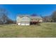 Large backyard with a deck, detached garage, and plenty of green space at 1103 Wallington Nw Ct, Conyers, GA 30012