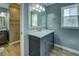 Bathroom with a stylish vanity, marble countertop, and blue walls and flooring at 1103 Wallington Nw Ct, Conyers, GA 30012