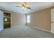 Carpeted bedroom featuring a ceiling fan, neutral walls, and generous space with natural light at 1103 Wallington Nw Ct, Conyers, GA 30012