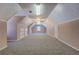 Expansive bonus room with cozy carpeting, built-in cabinets, and unique ceiling design at 1103 Wallington Nw Ct, Conyers, GA 30012