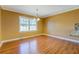Dining room with hardwood floors, bright windows, and chandelier lighting at 1103 Wallington Nw Ct, Conyers, GA 30012