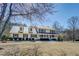 Charming two-story home with a metal roof, covered porch, and well-maintained landscaping at 1103 Wallington Nw Ct, Conyers, GA 30012