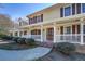 Welcoming front porch with white railings, a decorative front door, and manicured shrubs at 1103 Wallington Nw Ct, Conyers, GA 30012