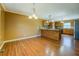 Open-concept kitchen featuring hardwood floors and an extended granite countertop island at 1103 Wallington Nw Ct, Conyers, GA 30012
