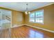 Cozy living room featuring hardwood floors, wainscoting, and a bright window overlooking the yard at 1103 Wallington Nw Ct, Conyers, GA 30012