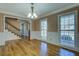 Bright living room features wainscoting, hardwood floors, and large windows with natural light at 1103 Wallington Nw Ct, Conyers, GA 30012