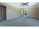 Large bedroom with neutral walls, plush carpeting, and open doorways leading to closet and bath at 1103 Wallington Nw Ct, Conyers, GA 30012