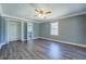 Large main bedroom with a ceiling fan, closet, and attached bathroom at 1103 Wallington Nw Ct, Conyers, GA 30012