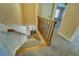Carpeted stairs with wood handrail and spindles, offering a seamless transition between levels at 1103 Wallington Nw Ct, Conyers, GA 30012