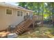 Back of home featuring a wooden deck, stairs, and landscaped backyard at 187 Gilberts Way, Temple, GA 30179