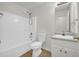 Bright bathroom featuring a shower-tub combo, toilet, and a vanity with a light grey countertop at 187 Gilberts Way, Temple, GA 30179