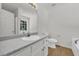 Bright bathroom featuring a bathtub, toilet, and vanity with countertop space at 187 Gilberts Way, Temple, GA 30179