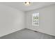 Cozy bedroom featuring neutral carpet, white walls, a window, and ceiling light at 187 Gilberts Way, Temple, GA 30179