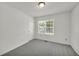 Neutral bedroom with gray carpet, a bright window, and a closet space at 187 Gilberts Way, Temple, GA 30179