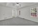 Bright bedroom boasts tray ceiling, fan, neutral carpet, and ensuite bath at 187 Gilberts Way, Temple, GA 30179