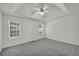Spacious bedroom featuring tray ceilings, a ceiling fan, two windows, and neutral carpeting at 187 Gilberts Way, Temple, GA 30179