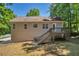 Rear view of home with deck, stairs, and landscaped yard at 187 Gilberts Way, Temple, GA 30179