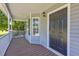 Inviting covered front porch with a stylish dark-colored front door and ample space for seating at 187 Gilberts Way, Temple, GA 30179