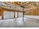 Spacious three car garage with concrete floor, insulated ceiling, and multiple garage doors at 187 Gilberts Way, Temple, GA 30179