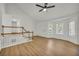 Bright and spacious living room with vaulted ceiling, wood floors, and views of the staircase at 187 Gilberts Way, Temple, GA 30179