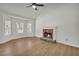 Cozy living room featuring a stone fireplace and ample natural light from the large windows at 187 Gilberts Way, Temple, GA 30179