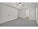Main bedroom with ensuite bath, tray ceiling, fan, neutral carpet, and plenty of space at 187 Gilberts Way, Temple, GA 30179