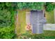 Aerial view of property featuring a landscaped backyard with a patio and firepit at 262 Sandhurst Ct, Suwanee, GA 30024