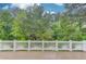 A wide view of a backyard with lush green trees at 262 Sandhurst Ct, Suwanee, GA 30024