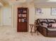 Basement room featuring a bookcase, leather sofa, and tile flooring at 262 Sandhurst Ct, Suwanee, GA 30024
