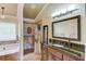 Primary bathroom features a soaking tub, walk-in shower, vanity with dark granite top and large framed mirror at 262 Sandhurst Ct, Suwanee, GA 30024