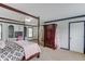 Bedroom featuring a four-poster bed, ceiling fan, and a built-in desk area with cabinetry at 262 Sandhurst Ct, Suwanee, GA 30024