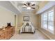 Bright bedroom with a ceiling fan, light walls, natural light and carpeted floors at 262 Sandhurst Ct, Suwanee, GA 30024