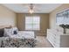 Cozy bedroom with a queen-sized bed, ceiling fan, and a white dresser with decorative accents at 262 Sandhurst Ct, Suwanee, GA 30024