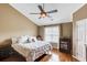 Comfortable bedroom featuring hardwood floors, a vaulted ceiling, and a cozy king-size bed with plush bedding at 262 Sandhurst Ct, Suwanee, GA 30024
