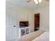 Bedroom featuring a bed, TV, and access to additional rooms through doorways at 262 Sandhurst Ct, Suwanee, GA 30024