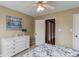 Comfortable bedroom featuring a dresser, ceiling fan, and access to additional rooms through doorways at 262 Sandhurst Ct, Suwanee, GA 30024