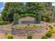 Stone entrance to the community with manicured flowerbeds and greenery at 262 Sandhurst Ct, Suwanee, GA 30024