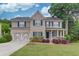 Charming two-story home with brick and siding, landscaped yard, and a two-car garage at 262 Sandhurst Ct, Suwanee, GA 30024