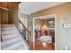Inviting home foyer with hardwood floors and staircase leading to second story, adjacent to a cozy den at 262 Sandhurst Ct, Suwanee, GA 30024