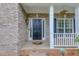 Close-up of the front door with brick facade and decorative welcome mat at 262 Sandhurst Ct, Suwanee, GA 30024